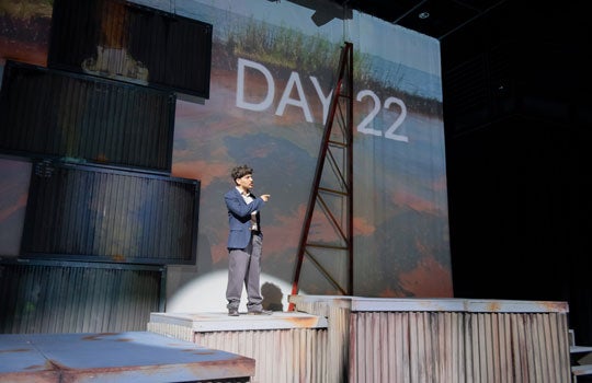 Photo of actor on stage with the status of day 22 of the spill